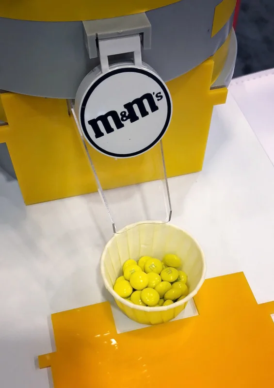 CandyBot dispenser filled with yellow M&Ms at Twilio SIGNAL