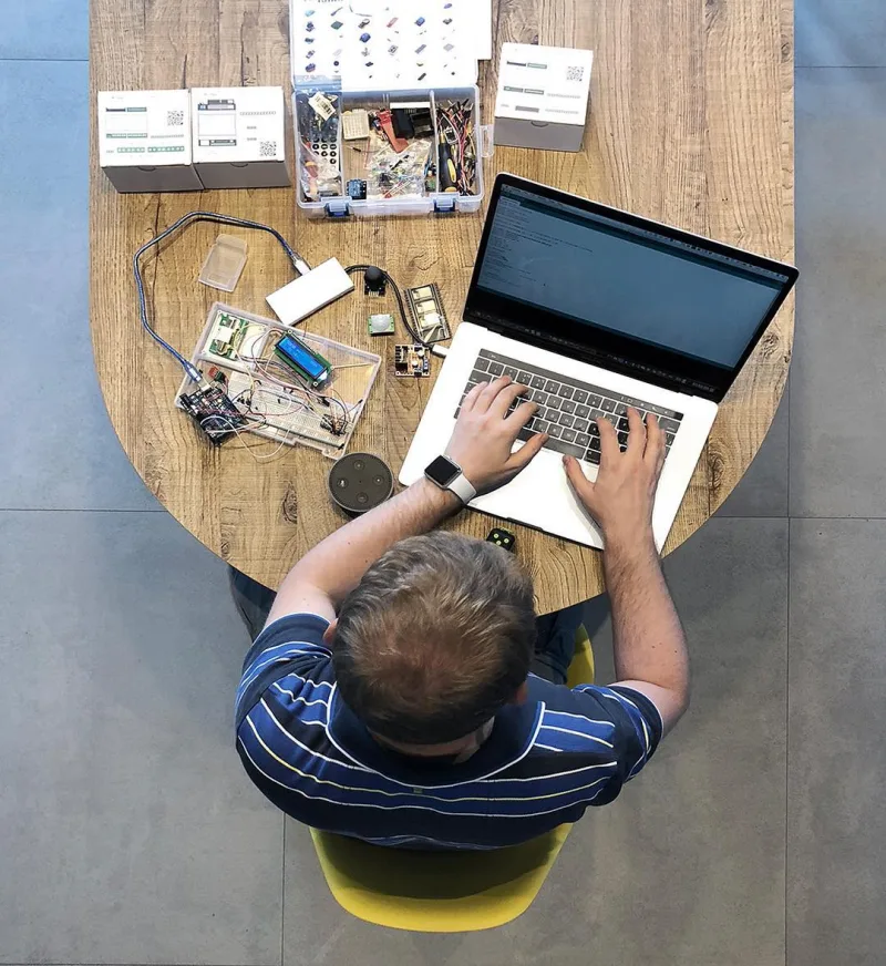 Kirill building an electronics prototype at a laptop