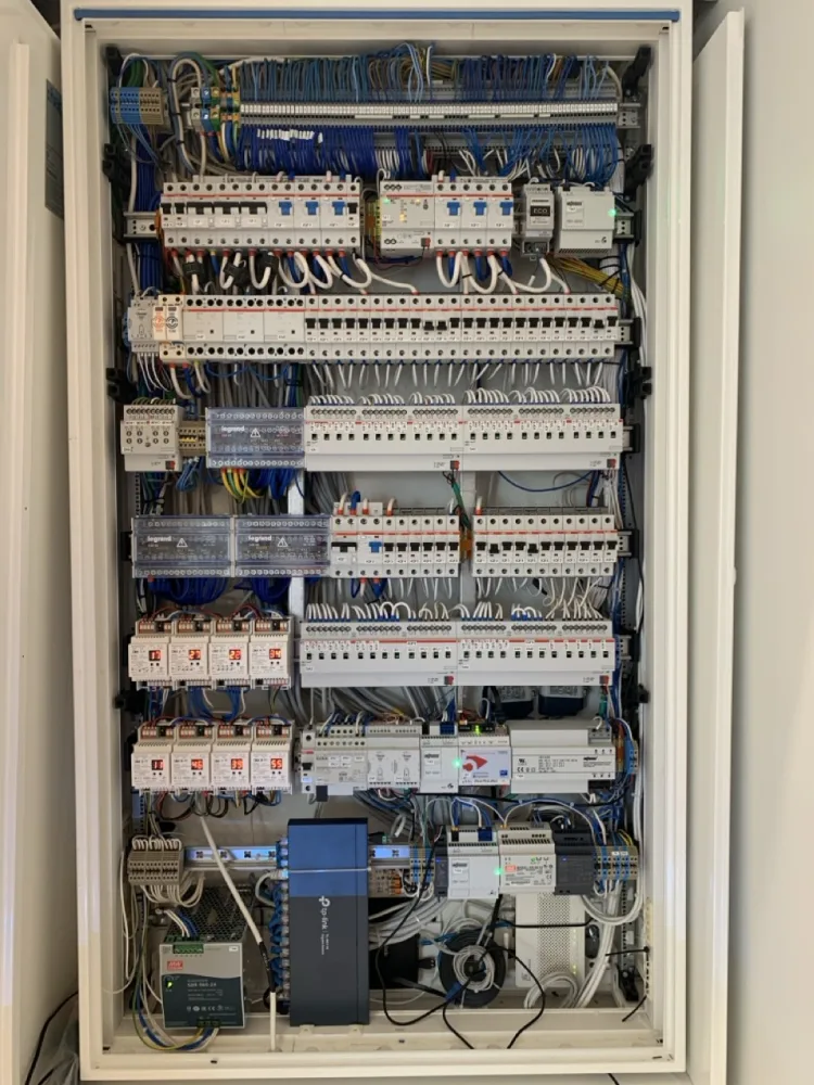 Open smart-home electrical and automation panel with controllers and wiring