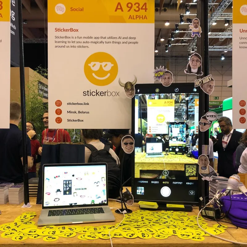 StickerBox exhibition booth with a large phone-shaped camera display