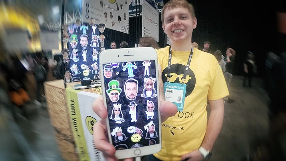 Kirill showing StickerBox stickers on an iPhone at Collision