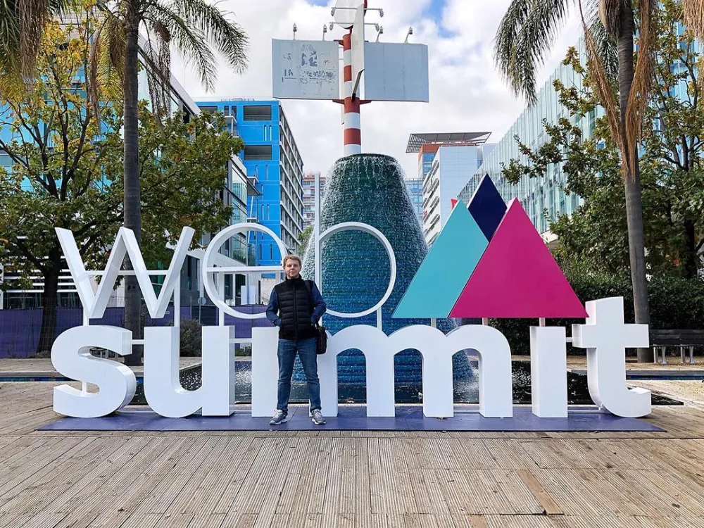 Kirill standing in front of the Web Summit sign in Lisbon